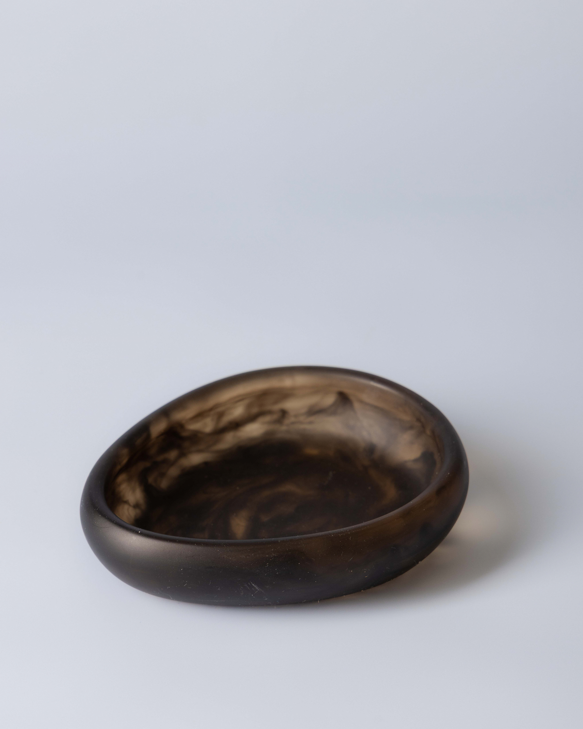 Chocolate resin small bowl, a deep brown marbled dish on a soft blue grey background