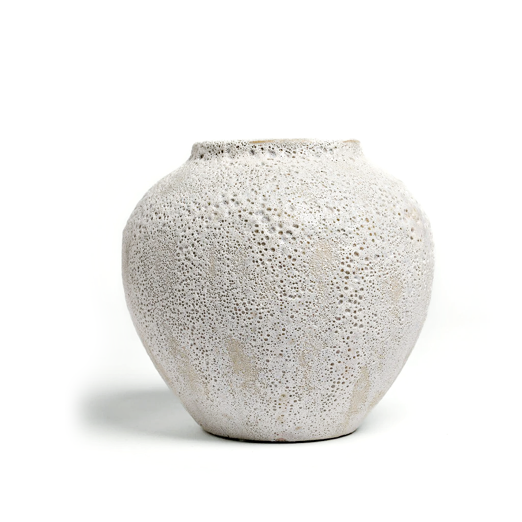 Short Seafoam vase with a heavily pitted coral like texture, shown alone on a white background
