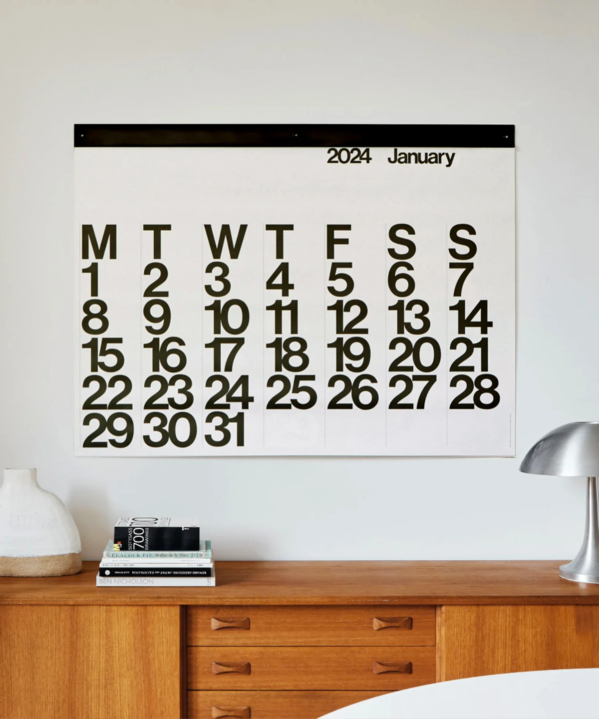 Stendig wall calendar displayed above a mid century timber sideboard