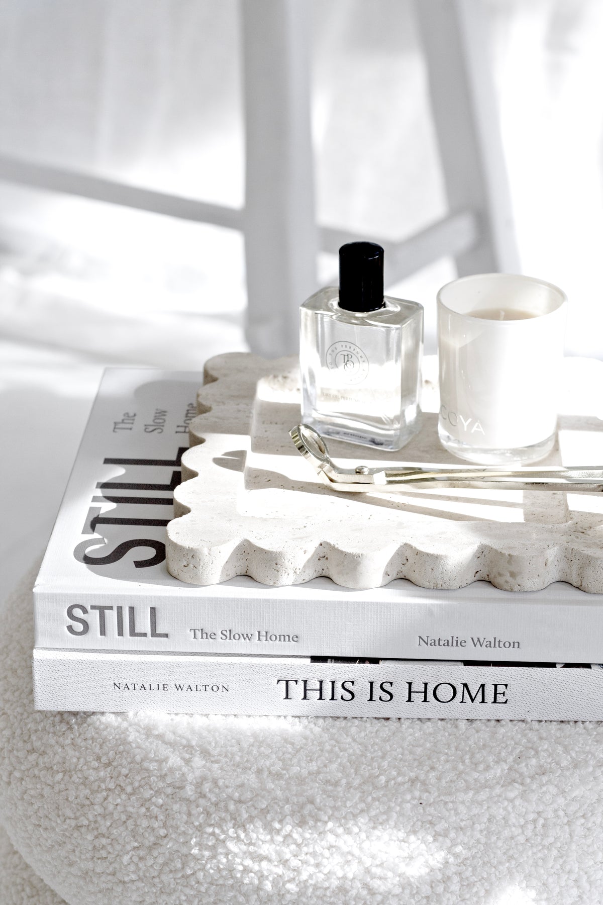 Still: The Slow Home by Natalie Walton styled with perfume and candle on a stone tray, modern minimalist coffee table decor.