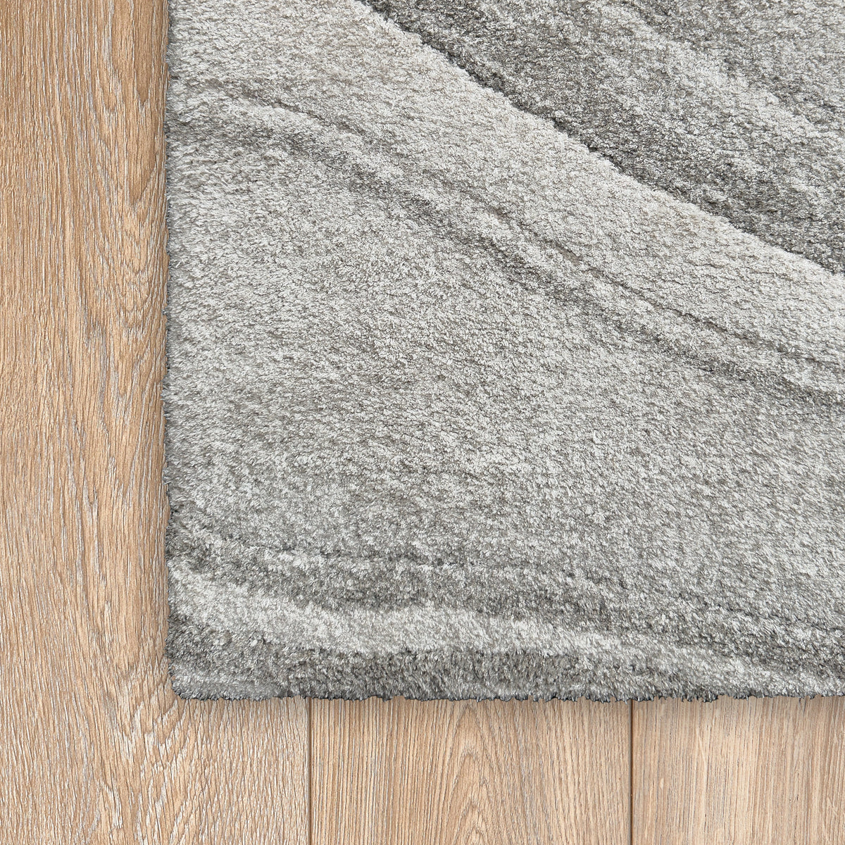Corner of the grey wave rug on a light timber floor