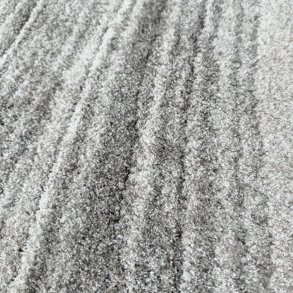 Close view of the plush grey and white wave lines