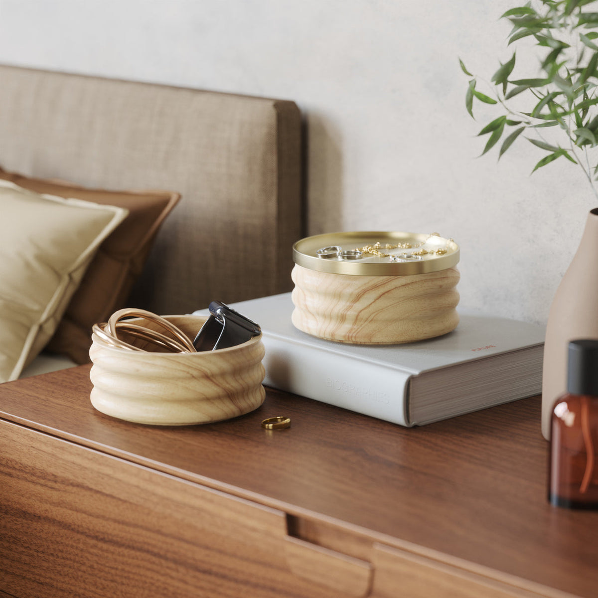 Umbra Tesora storage box in natural and brass on a bedside table with jewellery