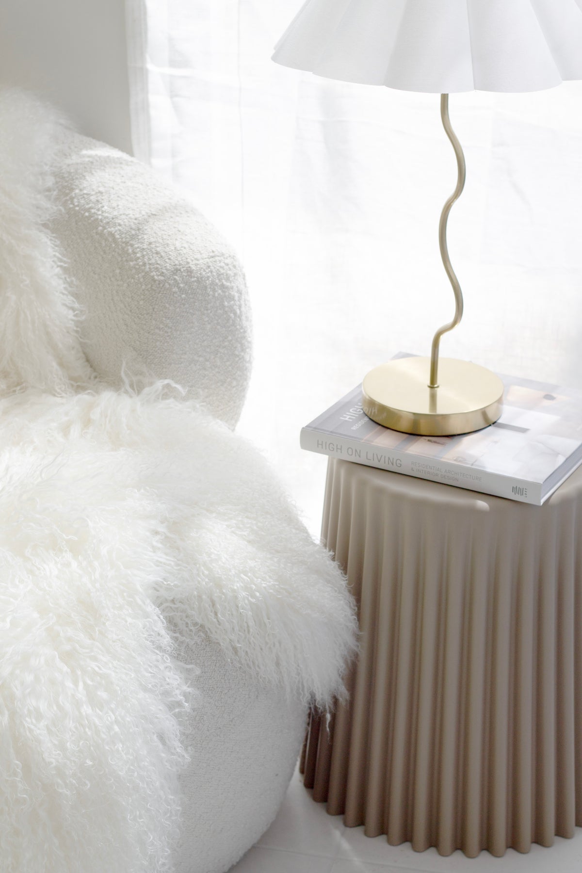 Ribbed polyurethane side table styled as bedside table with lamp and book