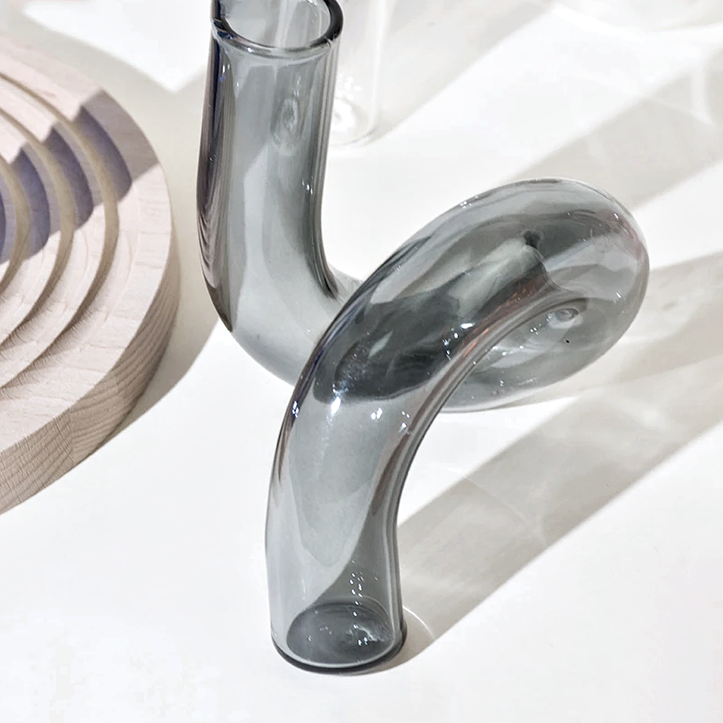 Close up of the smoke J-Curve vase at an angle in strong sunlight