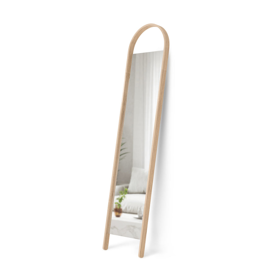 Umbra Bellwood arched wood frame leaning mirror in bedroom corner