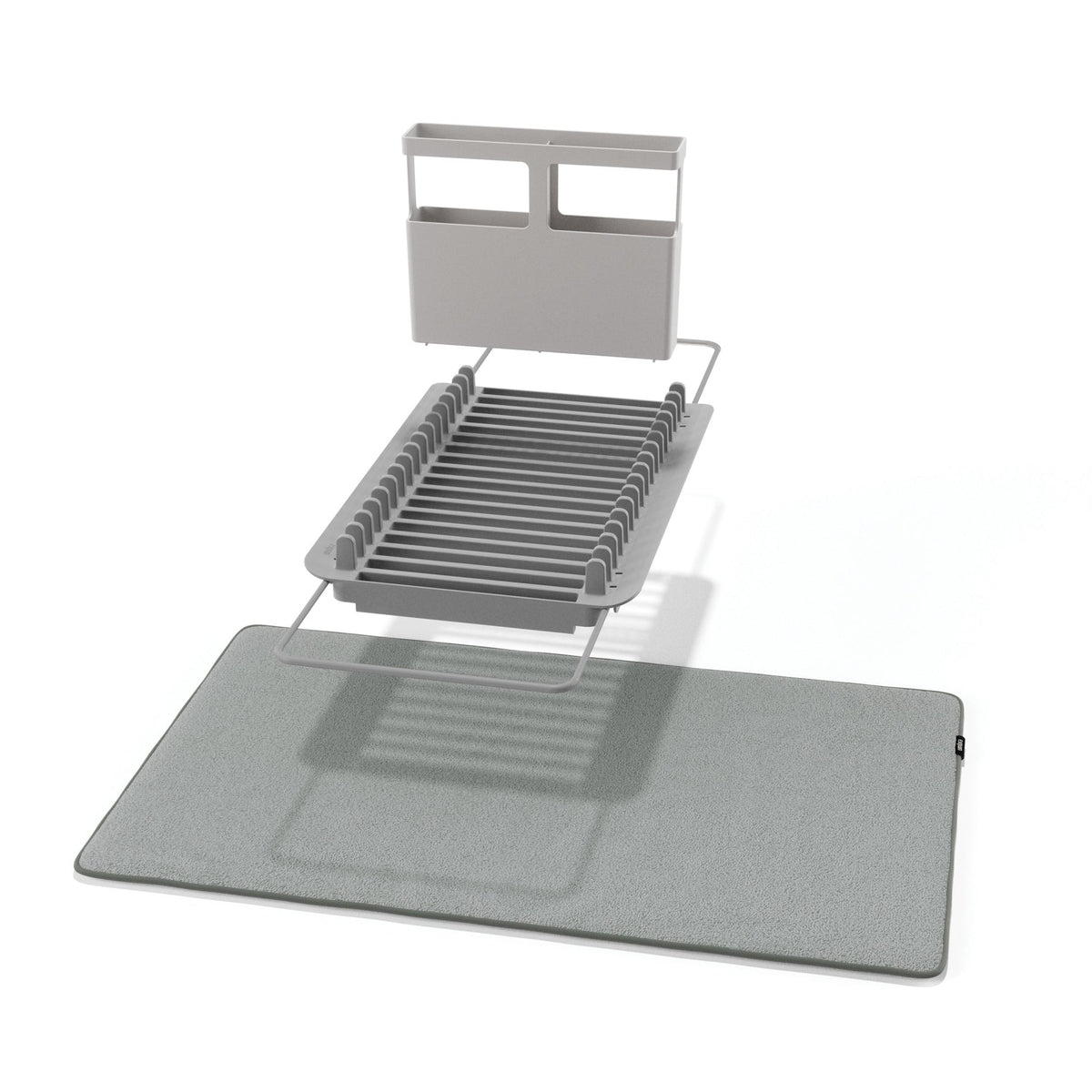 Umbra Udry dish rack in charcoal folded flat beside its grey microfibre drying mat