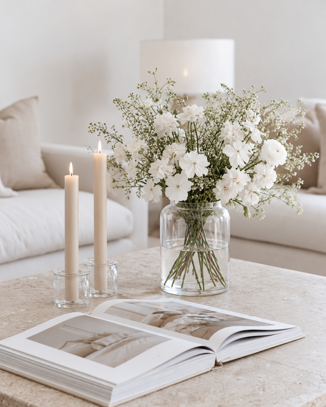 Zakkia Deco Vase Tall Clear Glass with white flowers on a travertine coffee table