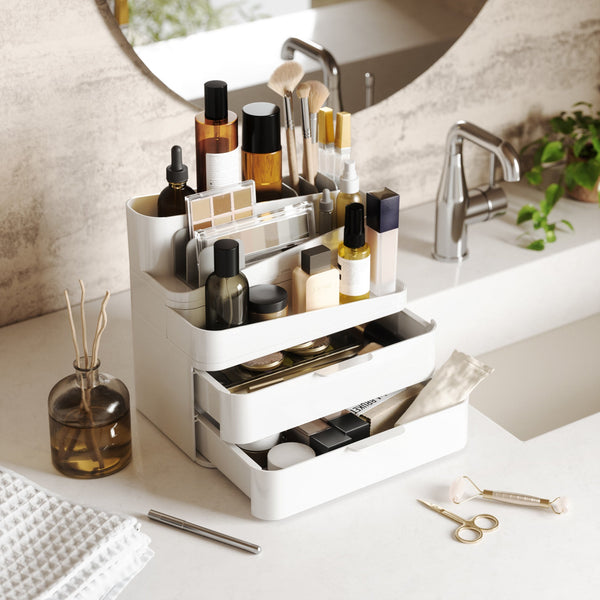 A white Umbra beauty station with a sink, mirror, and Glam Cosmetic Organizer Large.