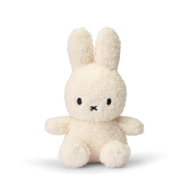 A Miffy Sitting Teddy Cream (23cm) made from recycled PET bottles sitting on a white surface.