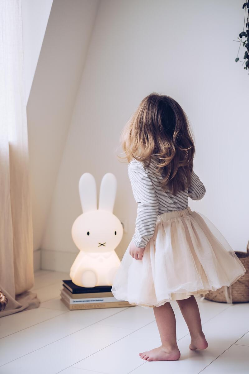 A young girl standing in front of the glowing Mr Maria Miffy Star Light