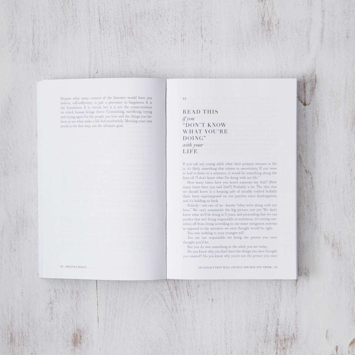 101 Essays That Will Change the Way You Think by Brianna Wiest resting on a wooden surface