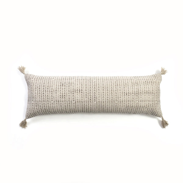 A KAVI BOLSTER W/COTTON INNER by Flux Home, with tassels and a patterned feature.