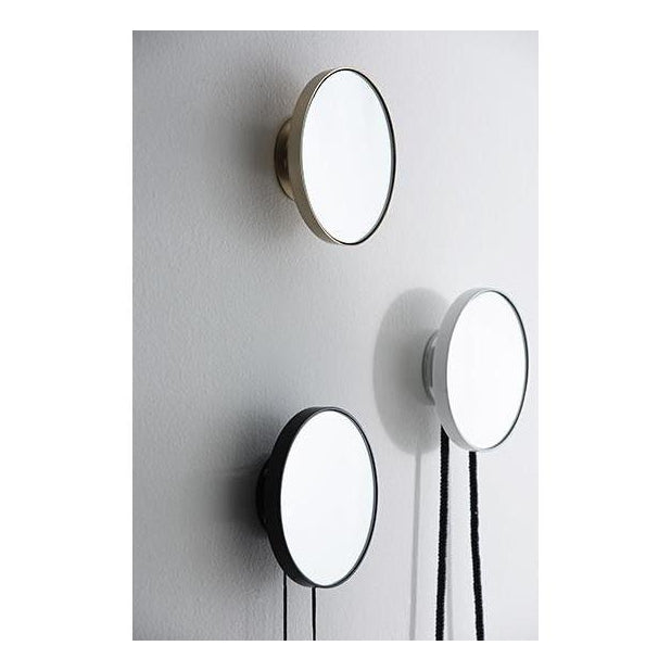 White mirror hook mounted on a wall