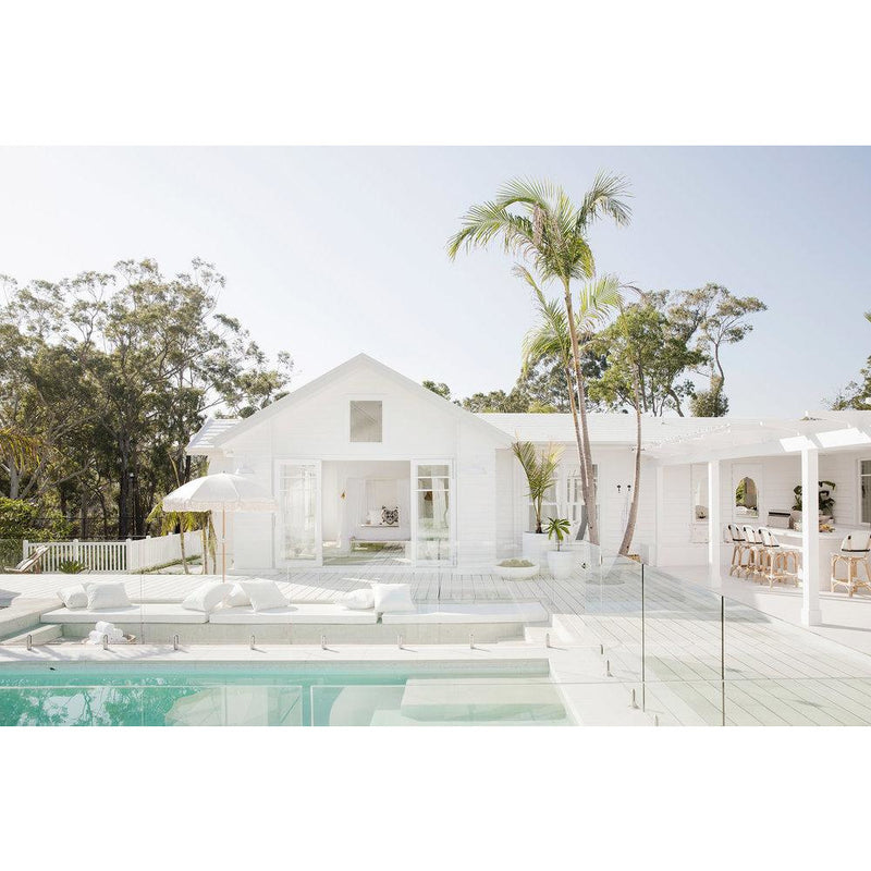 A house with a pool and lounge chairs, perfect for Instagram, featuring the Three Birds Renovations - 400+ Renovation and Styling Secrets Revealed by Books.