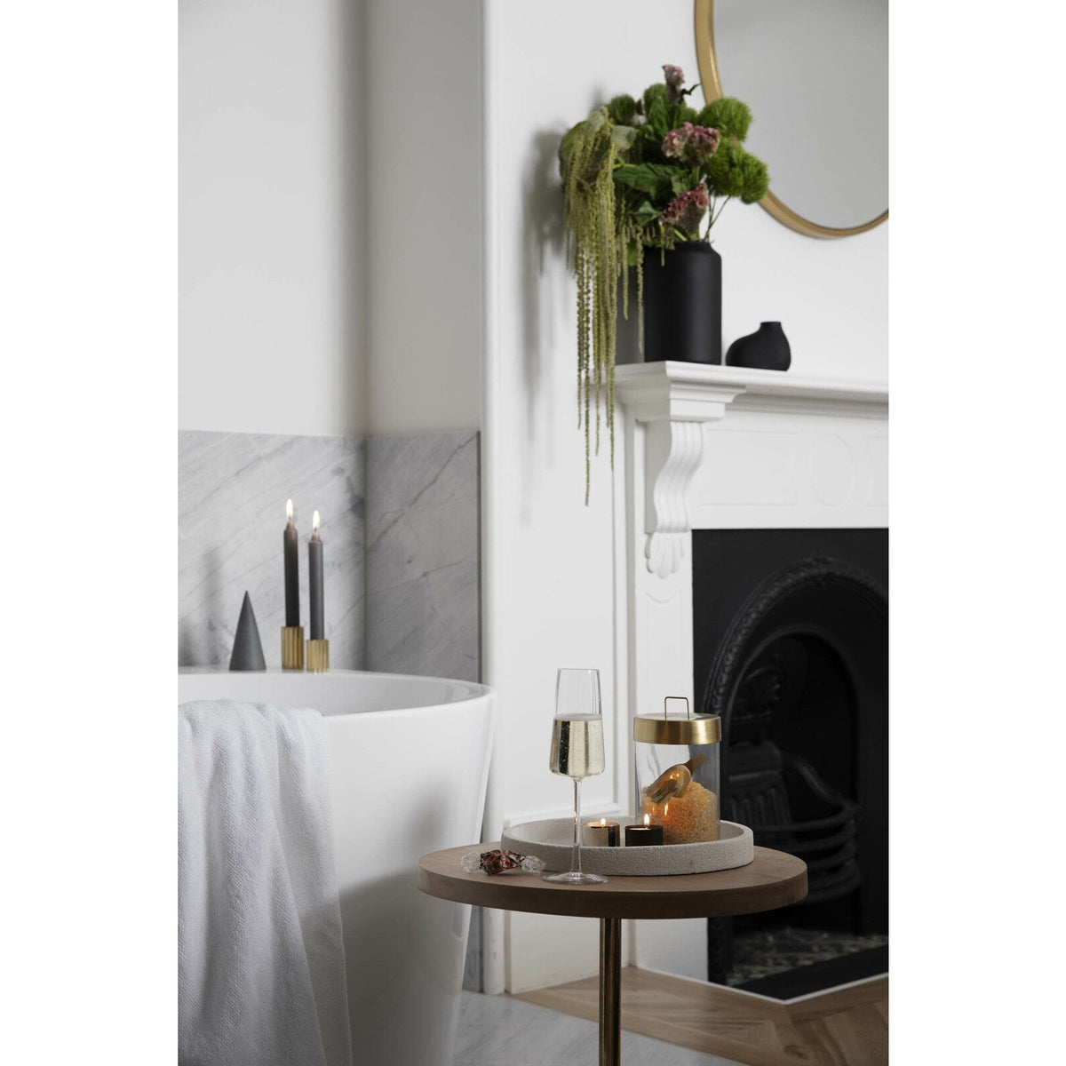 A bathroom with a Zakkia Tealight Candle Holder - Set of 3 Silver and a fireplace.
