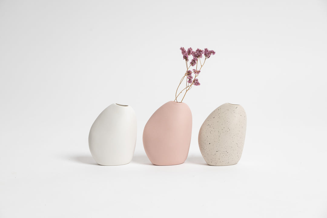 Three Great Harmie vases with flowers in them, beautifully crafted by Vietnamese artisans, displayed on a pristine white surface. (Brand: Ned Collections)