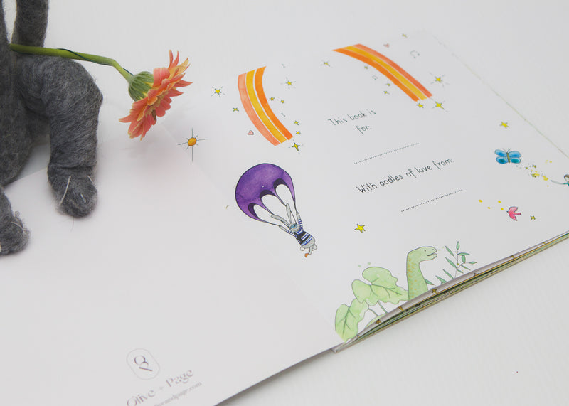 Watercolour spread from In a World Full of Magic with a hot air balloon, beside a plush toy