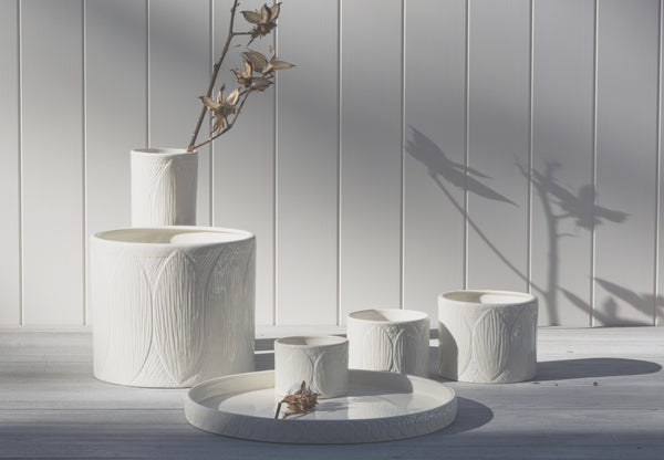 Four Zakkia Kapok Pot - Set of 3 - White vases on a wooden table.