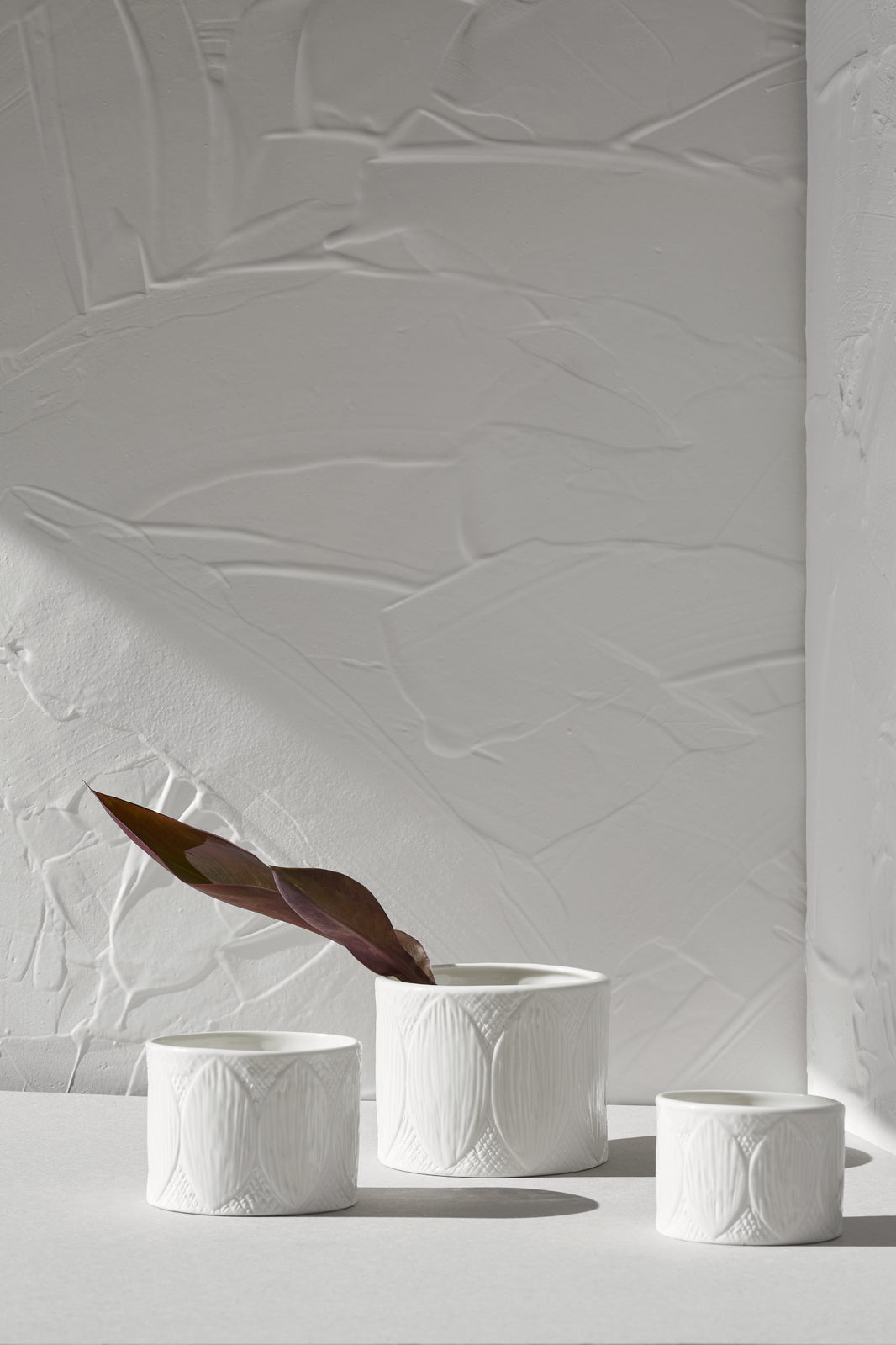 Three Zakkia Kapok Pot - Set of 3 - White bowls sitting on a white table.