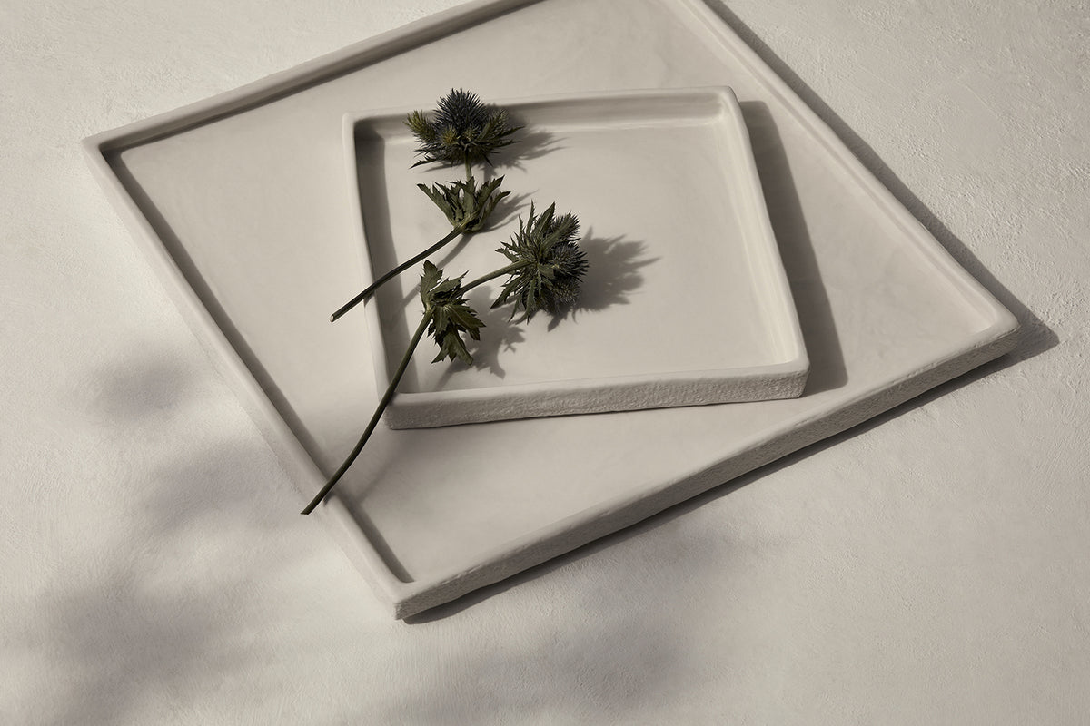 A Zakkia Burlap Square Tray Large - White with flowers on it.