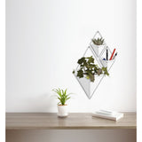 A white Umbra Trigg Wall Vessel | Large - White/Nickel displaying an indoor plant, serving as a decorative planter.