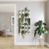 A living room adorned with a DIY green wall featuring Umbra Floralink wall vessels.