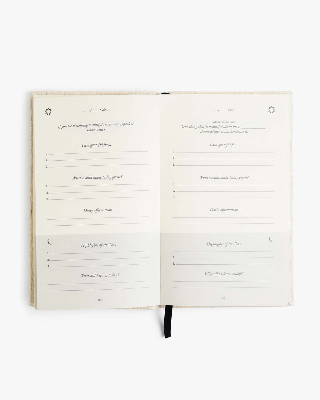 Five Minute Journal open flat at a daily page with a ribbon marker