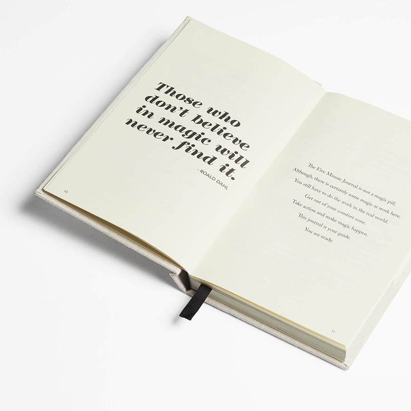 Five Minute Journal open at an angle to a page with a large printed quote