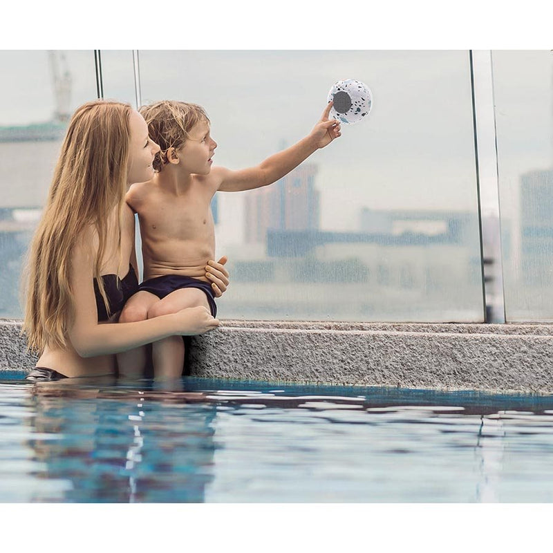 An Albi Wireless Shower Speaker - Assorted Natural Prints, woman and child enjoy a swim in a pool.