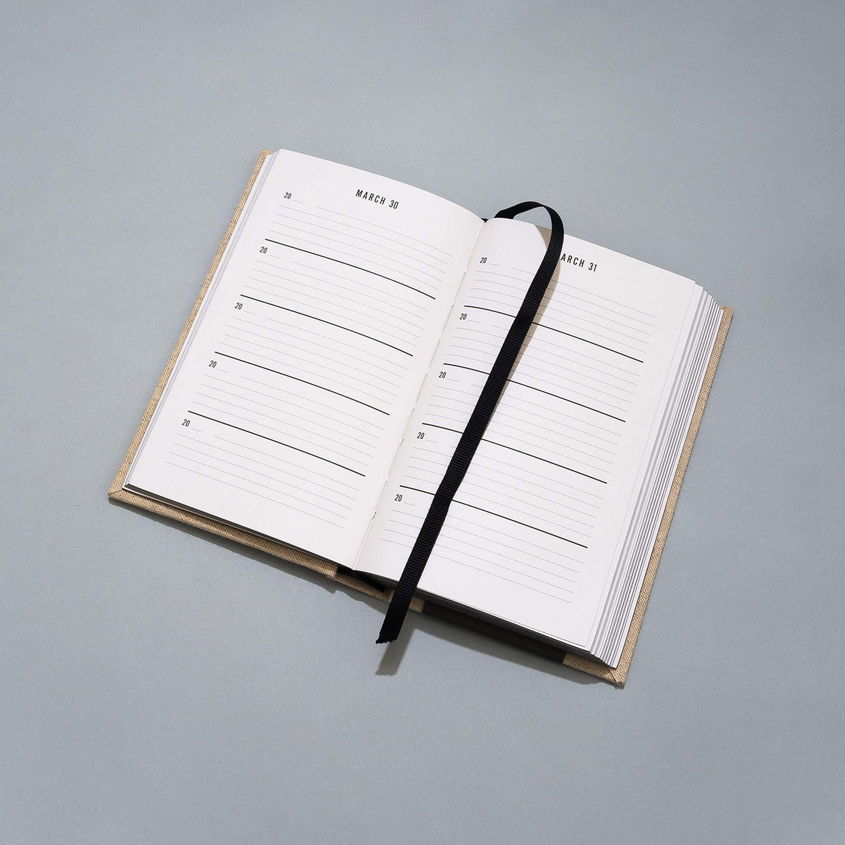 Open One Line a Day journal with its black ribbon marker laid across the page