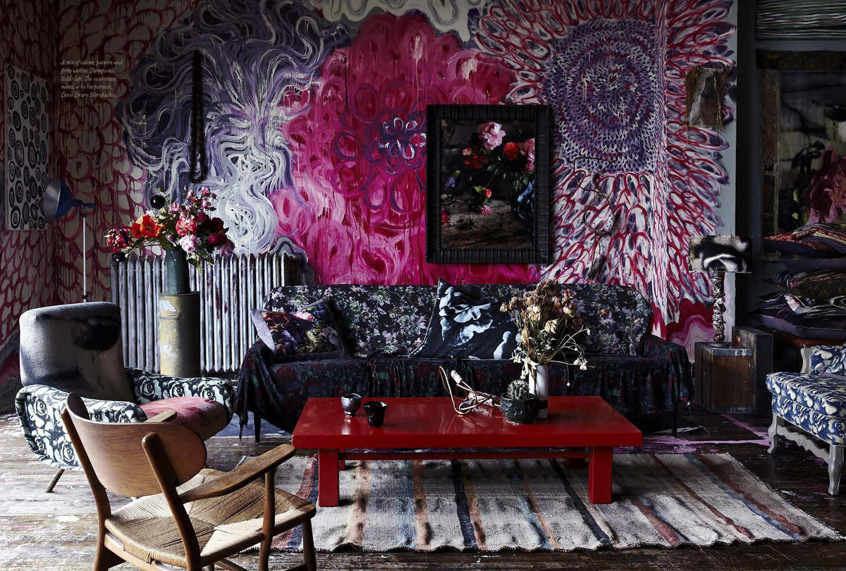 A living room with colorful wallpaper showcasing its originality and Perfect Imperfect | The Beauty Of Accident Age And Patina furniture that adds a touch of beauty.
