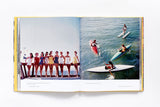 A Slim Aarons: Women book with pictures of people on surfboards.