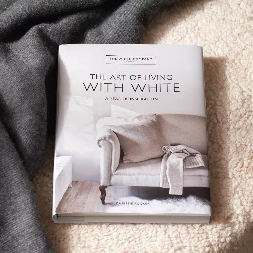 The Art of Living With White page spread showing a white living room