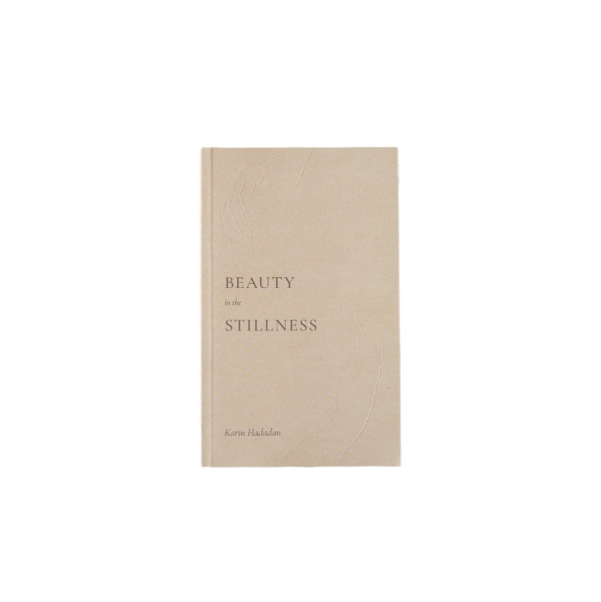 A "Beauty in the Stillness" book on a wooden surface with the words 'beauty and the beast'. (Brand: Thought Catalog)