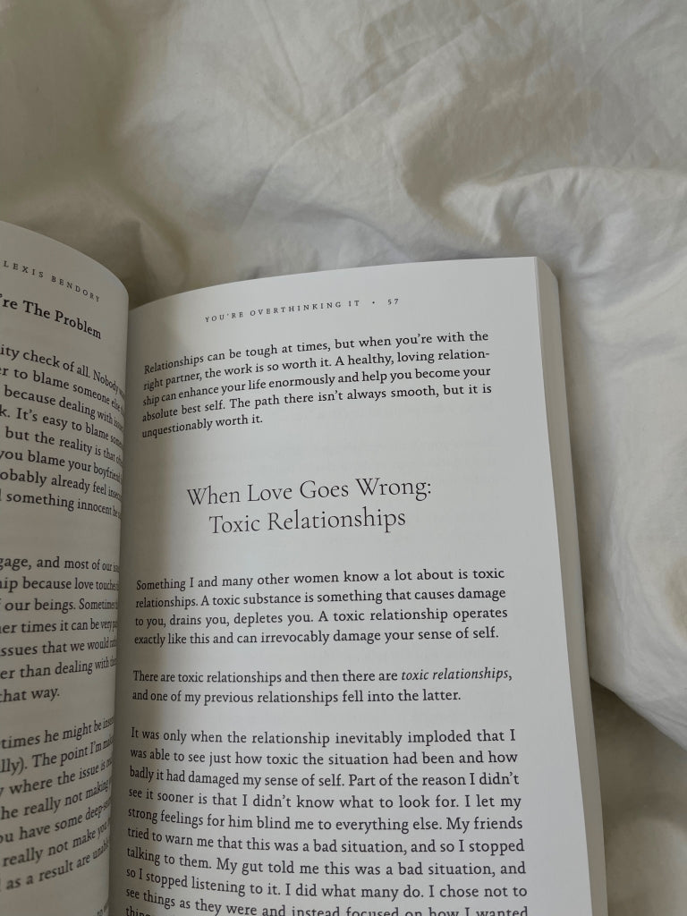 Book open on white bedding, second spread