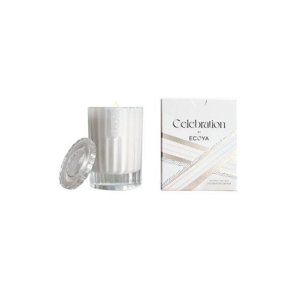 An Ecoya Celebration | White Musk & Warm Vanilla Mini Candle in a box with a burn time indicator next to it.