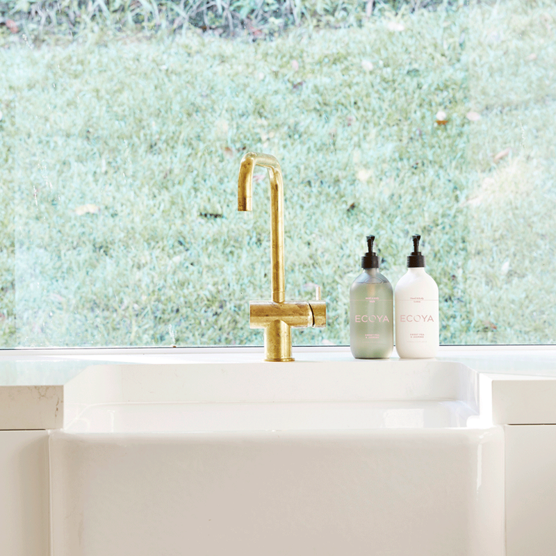 A white Scandinavian hand & body lotion with a fragranced Ecoya faucet.