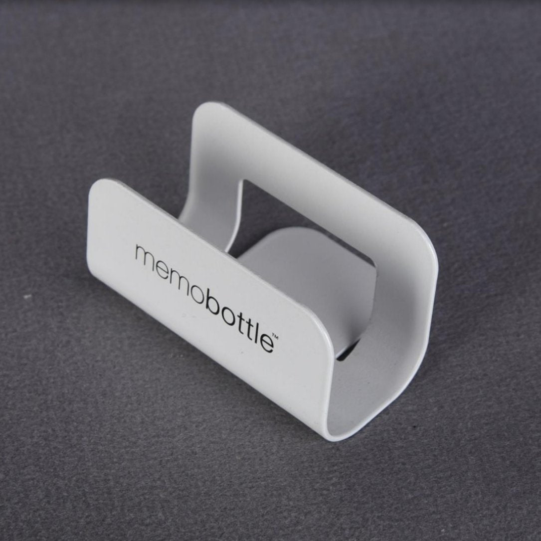 White Memobottle desk stand photographed against a dark grey background