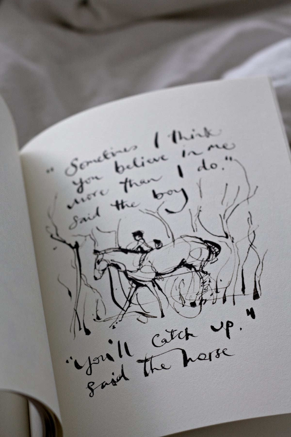 An open Charlie Mackesy | The Boy, The Mole, The Fox and The Horse book.