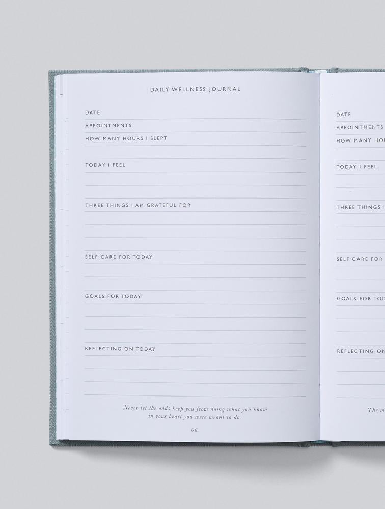 Open journal showing daily wellness journal pages