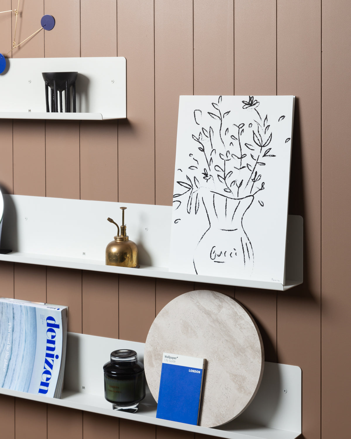 A Made of Tomorrow FOLD Display Ledge 600mm ∙ White with display space holding various items.