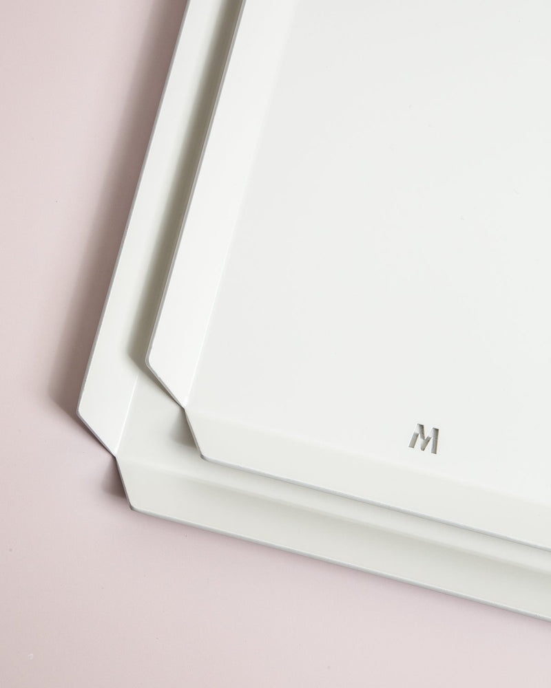 A white Made of Tomorrow FOLD tray with the letter m on it.