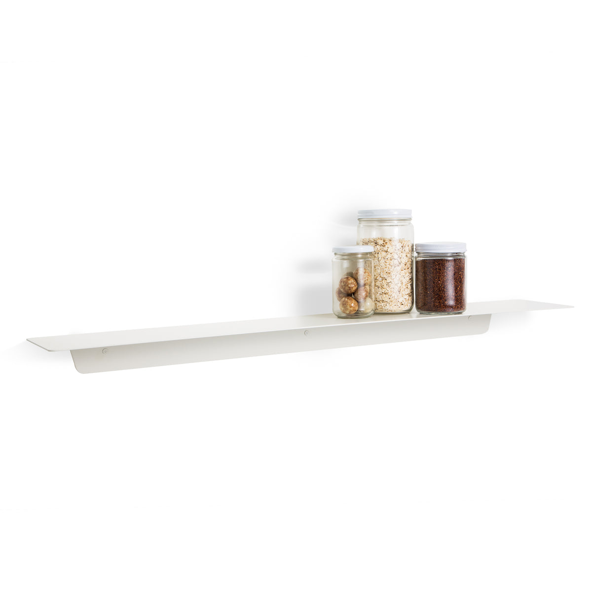 The FOLD Ledge 900mm ∙ White, made by Made of Tomorrow, is a white shelf featuring jars filled with various nuts. This versatile shelf seamlessly blends into any kitchen decor, adding functionality while displaying beloved