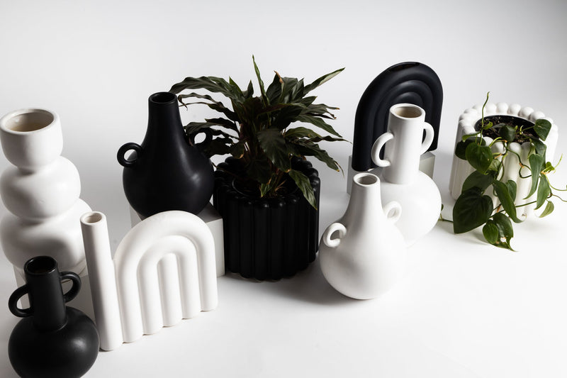 A group of HAROLD VASE vases with a matte finish in the black and white range from Ned Collections.