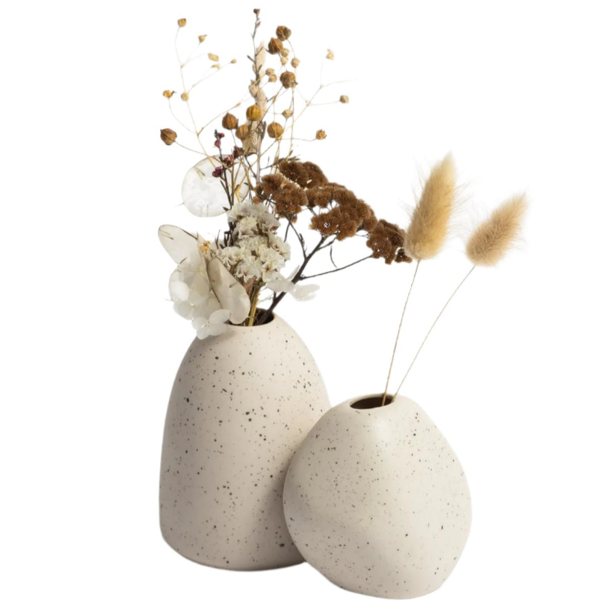Two Little Rick Vases from Ned Collections with dried flowers from Vietnamese Artisans on a white surface.