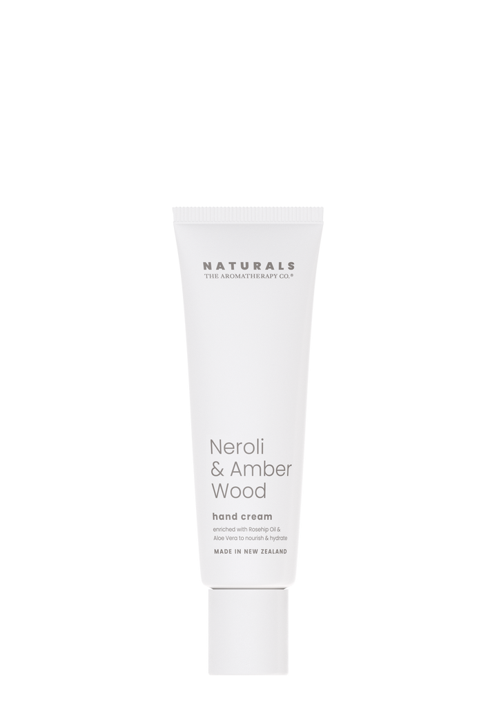 Naturals Neroli & Amber Wood hand cream in a white tube on a white background