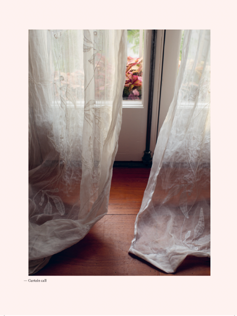 A white curtain is hanging in front of a window in a cozy Home | Victoria Alexander.