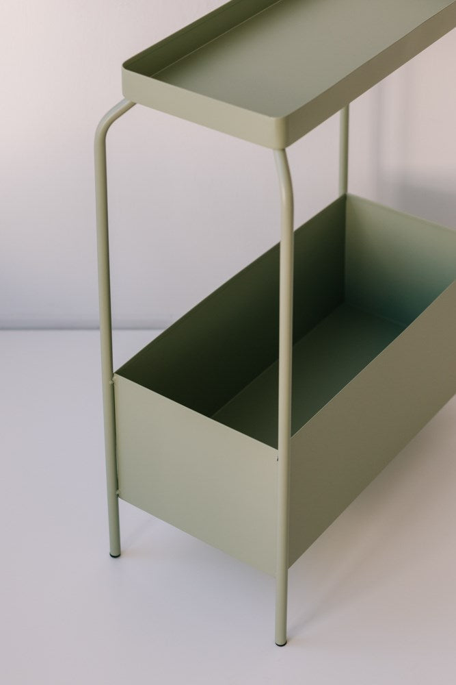 A decorative green Metal Planter Stand - Various Options with two drawers on it. (Brand Name: Garcia Home)