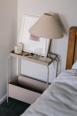 A Garcia Home bed with a bedside table and a decorative lamp.